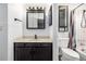 Bathroom with vanity and cabinet, shower/tub combo, and tiled walls at 9832 High St, Thornton, CO 80229