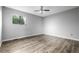Spacious primary bedroom with laminate flooring and a large window at 9832 High St, Thornton, CO 80229