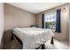 Inviting bedroom with modern lighting fixture and window with curtains at 9832 High St, Thornton, CO 80229
