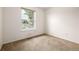 Empty bedroom features a large window offering ample natural light at 9832 High St, Thornton, CO 80229