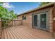 Spacious outdoor deck with wood plank flooring, overlooking the backyard at 9832 High St, Thornton, CO 80229
