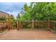 Wooden deck with wood railings overlooking lush green trees at 9832 High St, Thornton, CO 80229