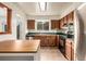 Bright kitchen featuring warm wood cabinets, updated appliances, and tile flooring at 9832 High St, Thornton, CO 80229