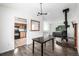 Open concept living space features a wood burning stove, and adjacent dining and kitchen at 9832 High St, Thornton, CO 80229