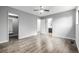 Neutral bedroom with laminate flooring, ceiling fan, and doorways to closet and bath at 9832 High St, Thornton, CO 80229