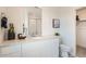 Bright bathroom with modern white cabinetry, a shower and ample counter space at 485 Bennett Ave, Bennett, CO 80102