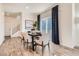 Elegant dining area with hardwood floors, stylish chairs, and abundant natural light at 485 Bennett Ave, Bennett, CO 80102