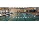 Indoor pool with bright lighting and clear blue water at 485 Bennett Ave, Bennett, CO 80102