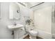 Bright bathroom with pedestal sink, white tile, and decorative accents at 5761 W 71St Ave, Arvada, CO 80003