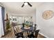 Dining room featuring a fireplace, table with chairs, and view into the living room at 5761 W 71St Ave, Arvada, CO 80003