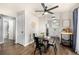 Bright dining area with wood floors, ceiling fan, and open access to kitchen at 5761 W 71St Ave, Arvada, CO 80003