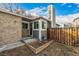 Charming front entrance with brick accents, gray trim, and a welcoming front door with storm door at 5761 W 71St Ave, Arvada, CO 80003