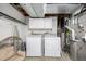 Functional laundry room with washer, dryer, storage cabinets, and ample space at 5761 W 71St Ave, Arvada, CO 80003