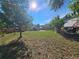 Large backyard, deck, wooden fence, pad and mature trees providing shade at 5886 S Nepal Way, Centennial, CO 80015