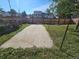 View of the backyard featuring concrete, wooden fence, and gate at 5886 S Nepal Way, Centennial, CO 80015