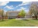 Spacious backyard features a lush lawn, patio and back of home at 5886 S Nepal Way, Centennial, CO 80015