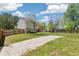 Backyard features an expansive driveway, grassy lawn, and fenced perimeter at 5886 S Nepal Way, Centennial, CO 80015