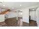 Open basement with wood floors, stairs, and a laundry area at 5886 S Nepal Way, Centennial, CO 80015