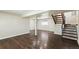 Spacious basement with wood-look flooring, stairs, and a small window providing natural light at 5886 S Nepal Way, Centennial, CO 80015