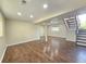 Spacious basement with hardwood floors, neutral paint, recessed lighting, and stairs leading to another level at 5886 S Nepal Way, Centennial, CO 80015