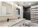 Updated bathroom with double sinks, granite countertops, and tiled shower with decorative shower curtain at 5886 S Nepal Way, Centennial, CO 80015