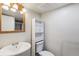 Traditional-style bathroom features a pedestal sink, matching mirror and built-in storage at 5886 S Nepal Way, Centennial, CO 80015