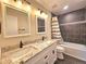 Modern bathroom with double vanity, granite countertop, and tiled shower at 5886 S Nepal Way, Centennial, CO 80015