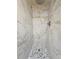 Updated stand up shower featuring marble tile walls and pebble tile flooring at 5886 S Nepal Way, Centennial, CO 80015