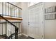 Inviting entryway features stairs, a light-colored door, and convenient wall-mounted storage baskets at 5886 S Nepal Way, Centennial, CO 80015