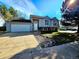Charming two-story home with stone accents, attached garage, and well-maintained front yard at 5886 S Nepal Way, Centennial, CO 80015