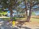 Well-kept home with a manicured lawn, mature trees, and a bright yellow fire hydrant at 5886 S Nepal Way, Centennial, CO 80015