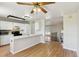 View of a modern kitchen connected to a spacious living room with a ceiling fan overhead at 5886 S Nepal Way, Centennial, CO 80015