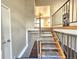 View of a carpeted staircase leading to the kitchen, with metal railings at 5886 S Nepal Way, Centennial, CO 80015