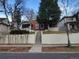 Charming red brick home with a welcoming front porch, stairs leading up to the entry, and a landscaped yard at 624 S Ogden St, Denver, CO 80209