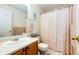 Standard bathroom with floral shower curtain, toilet, and vanity at 2070 E 125Th Pl, Thornton, CO 80241