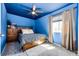 Bright bedroom featuring blue walls, star ceiling, window, and wood furnishings at 2070 E 125Th Pl, Thornton, CO 80241