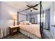 Bedroom with four poster bed, ceiling fan, and light purple walls at 2070 E 125Th Pl, Thornton, CO 80241