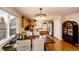 Elegant dining area with a modern chandelier and view into the kitchen at 2070 E 125Th Pl, Thornton, CO 80241