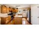 Well-lit kitchen features wood cabinets, stainless appliances, and central island at 2070 E 125Th Pl, Thornton, CO 80241
