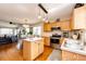 Open floor plan with eat-in kitchen, central island and stainless appliances at 2070 E 125Th Pl, Thornton, CO 80241