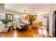 Bright eat-in kitchen features wood floors, stainless appliances, and central island at 2070 E 125Th Pl, Thornton, CO 80241
