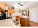 Bright kitchen features wood floors, wood cabinets and stainless appliances at 2070 E 125Th Pl, Thornton, CO 80241