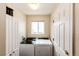 Functional laundry room with modern washer and dryer and white cabinets at 2070 E 125Th Pl, Thornton, CO 80241
