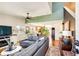Inviting living room with hardwood floors, large windows, and a comfortable gray couch at 2070 E 125Th Pl, Thornton, CO 80241