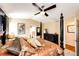Spacious main bedroom features four-poster bed, ceiling fan and ensuite bathroom at 2070 E 125Th Pl, Thornton, CO 80241