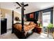 Well-lit main bedroom features four-poster bed, ceiling fan and stylish decor at 2070 E 125Th Pl, Thornton, CO 80241