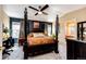 Spacious main bedroom features four-poster bed, ceiling fan and ensuite bathroom at 2070 E 125Th Pl, Thornton, CO 80241