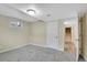 Carpeted basement with windows and a doorway that reveals wooden stairs at 12022 W Dakota Dr, Lakewood, CO 80228