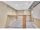 Basement featuring vinyl floors, pegboard walls, and a built in wooden table at 12022 W Dakota Dr, Lakewood, CO 80228