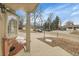 Home exterior featuring a covered porch, bay window, and well-maintained landscaping at 12022 W Dakota Dr, Lakewood, CO 80228